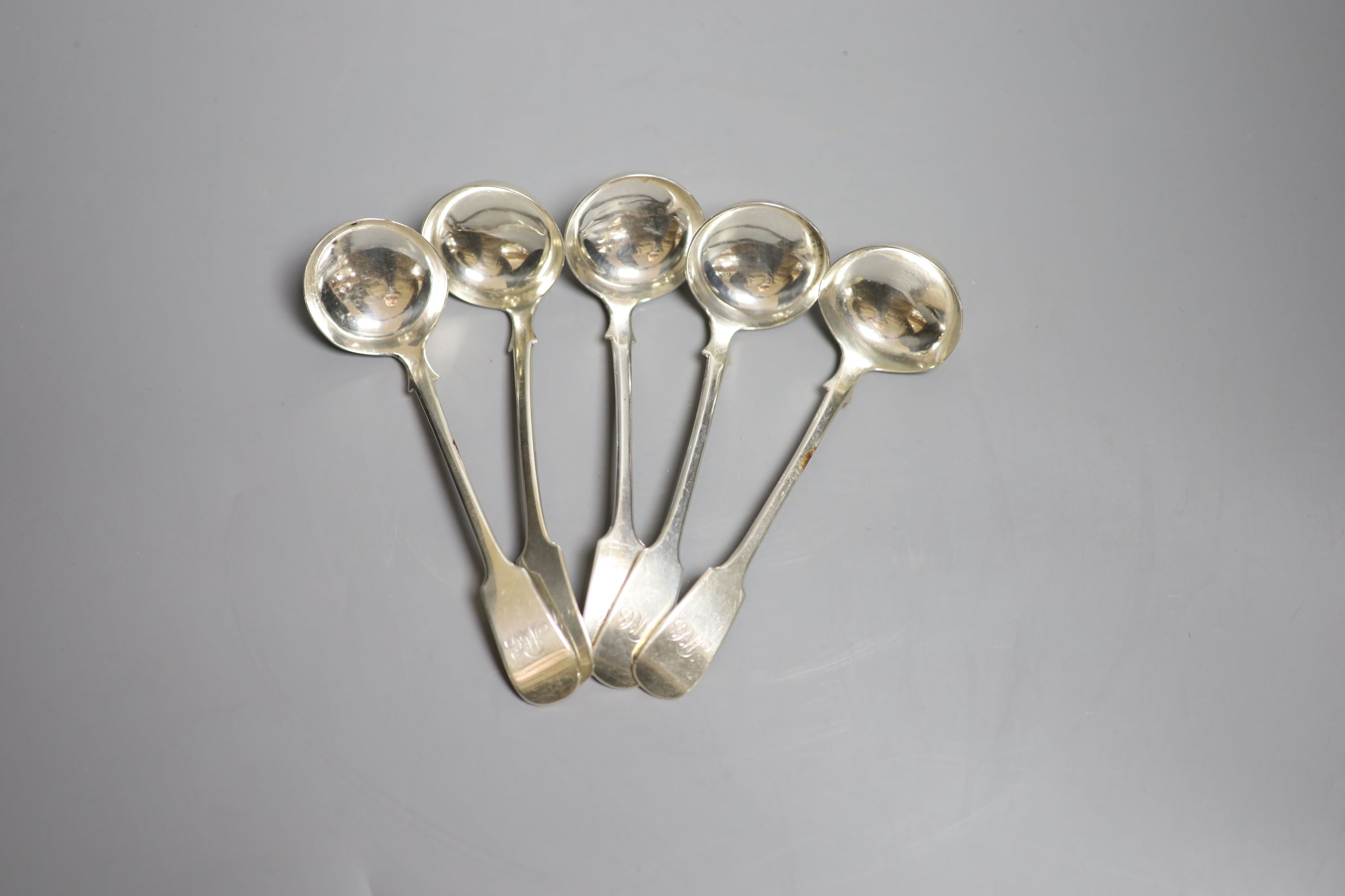 A set of five William IV Scottish provincial silver fiddle patter sauce ladles, Adam Burgess, Dumfries, circa 1835, 15.2cm, 180 grams, with engraved monograms.